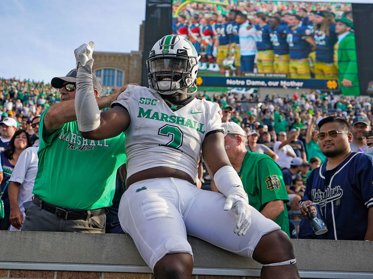 Marshall defensive lineman Elijah Alston celebrates with fans